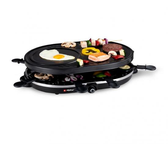Elektrischer Raclette-Grill mit Grillplatte, Pfännchen und Speisen wie Ei, Gemüse und Fleisch